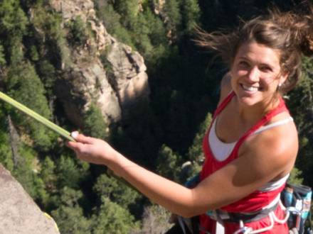 woman posing while rock climbing