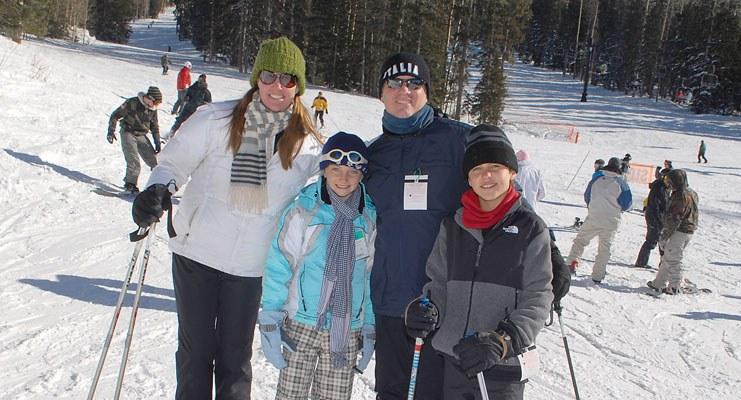 family on ski slope in spring