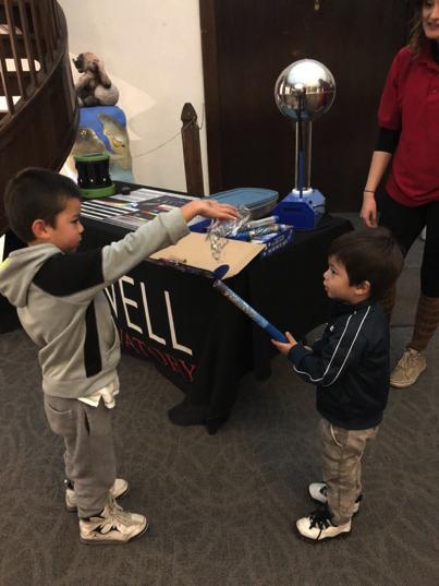 Kids play with items in a hands-on science exhibit at Lowell Observatory