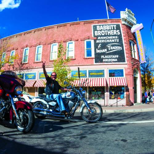 two bikers riding through downtown flagstaff
