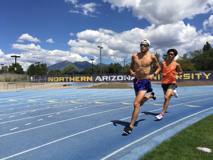 Two people running on the outdoor track at NAU
