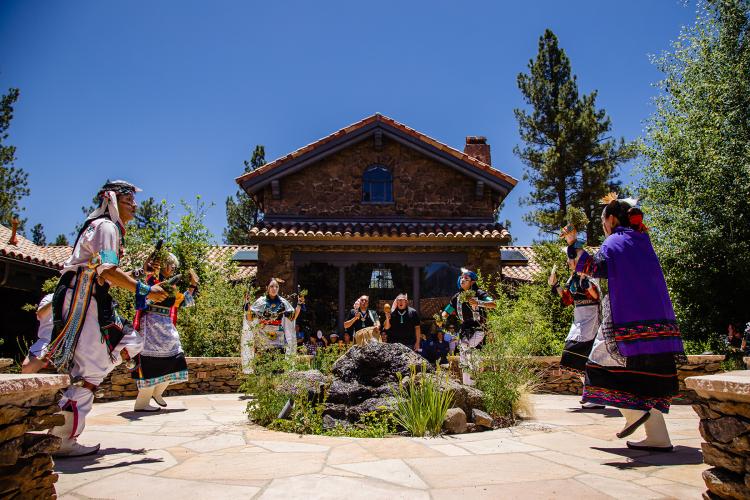 MNA Courtyard during festival with group of Native Americans performing traditional ceremonial dance in Flagstaff AZ