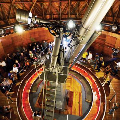 Aerial view of people gathered around the base of a telescope at Lowell Observatory