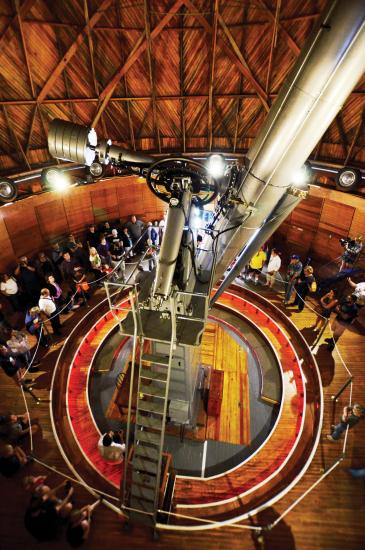 Aerial view of people gathered around the base of a telescope at Lowell Observatory