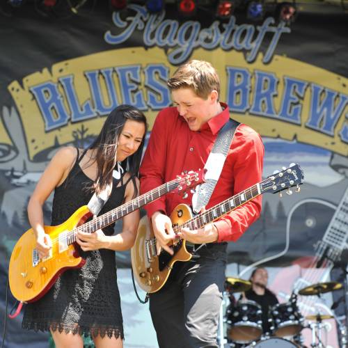 man and woman playing guitar at blues and brews concert event