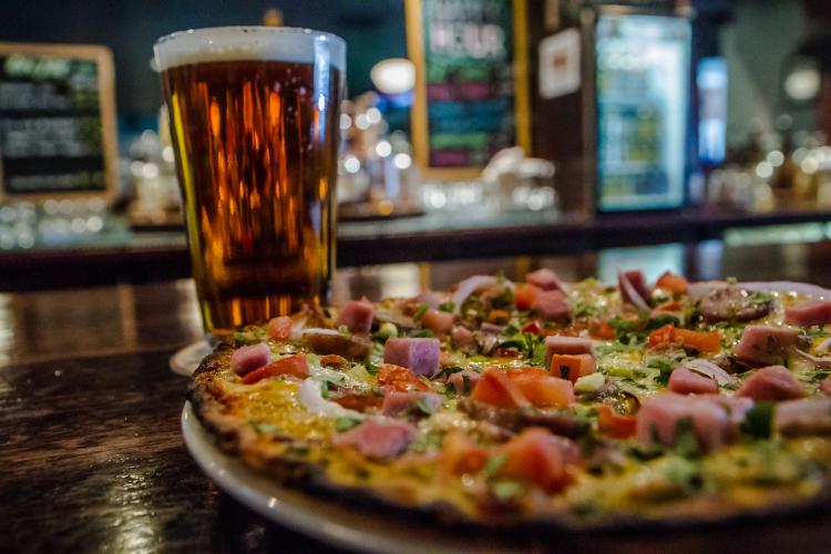 Pizza and beer on table at Beaver Street Brewery in Flagstaff, AZ