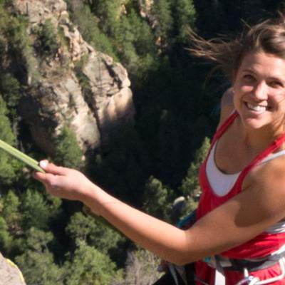 woman posing while rock climbing