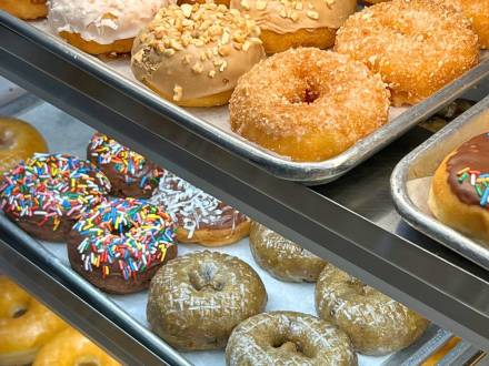 BoSa Donuts on a tray in a glass case