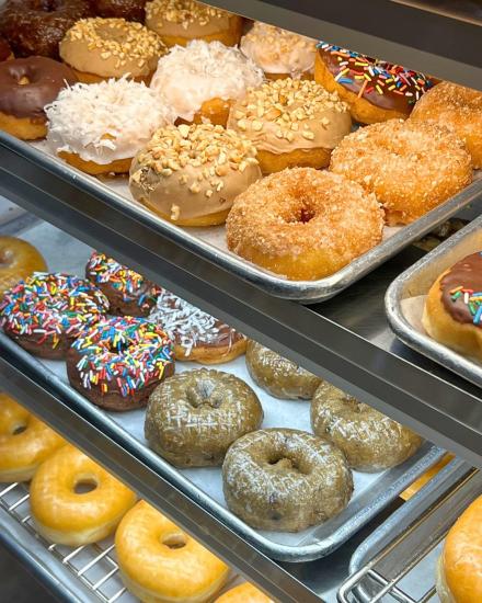 BoSa Donuts on a tray in a glass case