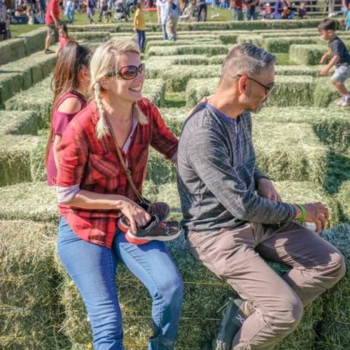 Two people sit on the edge of a short maze at the Cornucopia Fall Festival in Flagstaff, AZ.