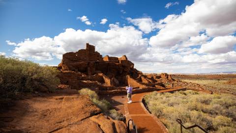 person taking a photo of the Wupatki National Monument