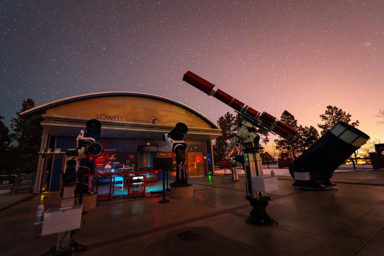 Telescopes pointing at the stars at dusk from Lowell Observatory.