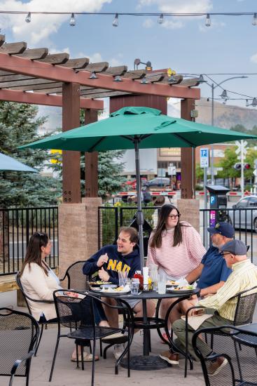 NAU students and family sitting in the outdoor patio at Lumberyard Brewery.