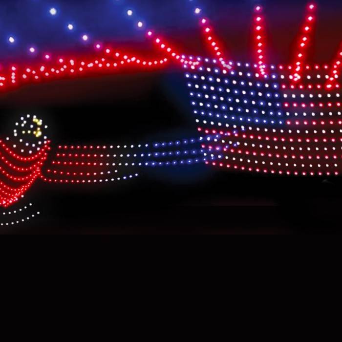 The Flagstaff 4th of July drone show displaying the US flag and bald eagle in red, white, and blue lights.