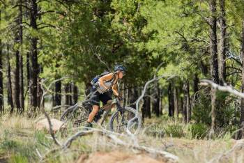 Woman riding a mountain bike in the forest