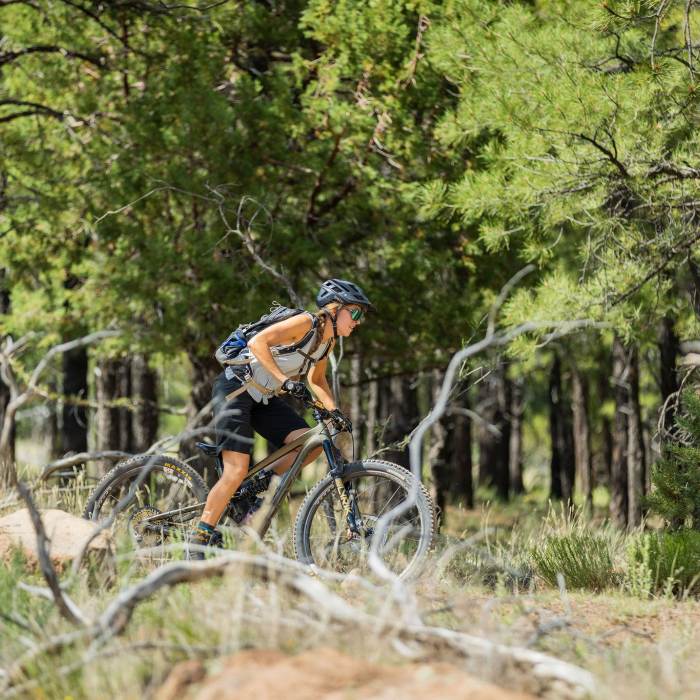 Woman riding a mountain bike in the forest