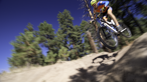 mountain biker riding downhill trail