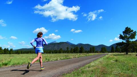 woman running on empty dirt path
