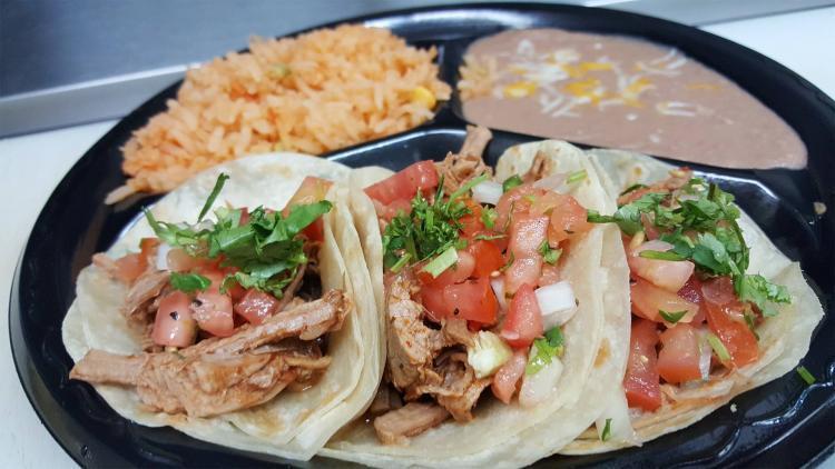 Three flour tortilla tacos from Tacos Los Altos