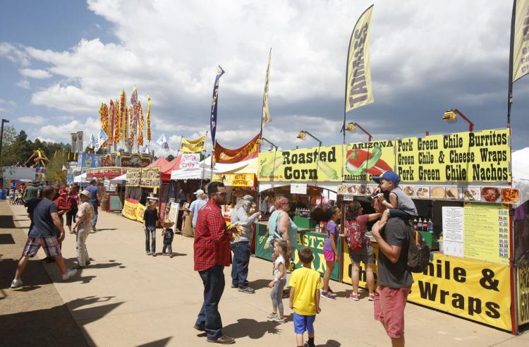 Crowd of people outside during the day at the county fair