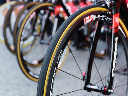 Close up of a row of bike tires. The tires are black with a yellow stripe