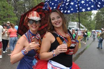 Two women wearing red white and blue clothing hold beers on Fourth of July in Flagstaff