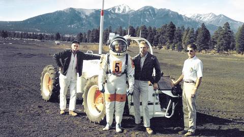 Vintage photo of group, one man dressed in astronaut suite completing Lunar Legacy tour in Flagstaff, AZ
