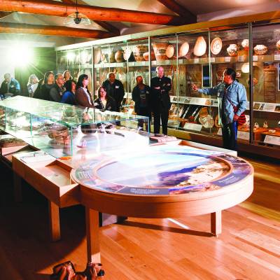 tour group looking at local artifacts in museum