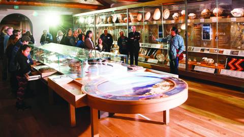 tour group looking at local artifacts in museum