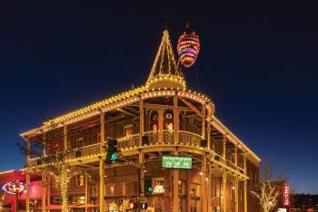 Evening exterior of the Weatherford Hotel during The Great Pinecone Drop event. A giant pinecone hangs from the hotel