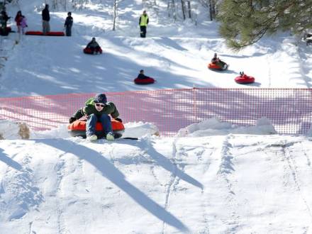 people snow tube down a snow covered mountain at Flagstaff Snow Park